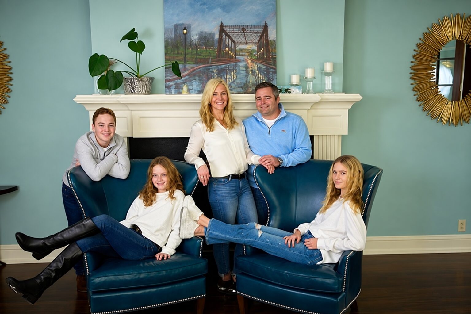 A family of five relaxing together around blue chairs in their Edina home